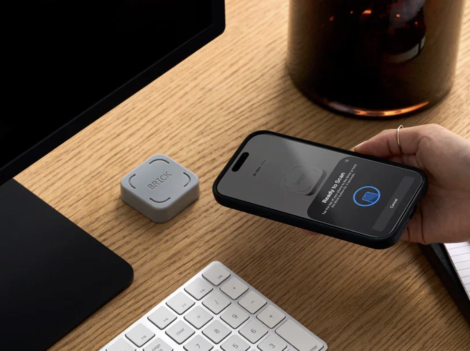 BRICK device next to a phone showing the scan prompt
