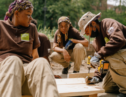 Green City Force members building a wooden structure